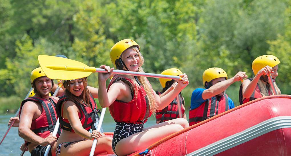 Group of woman white water rafting