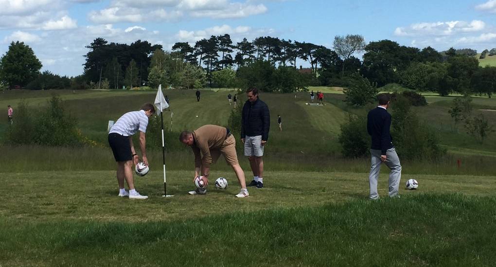 Players lining up their putts on a popular Footgolf course